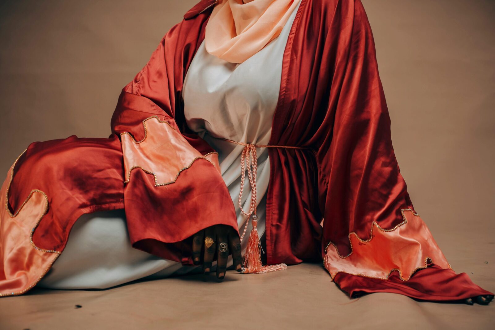 A woman in vibrant traditional attire with intricate patterns, exuding elegance and style.